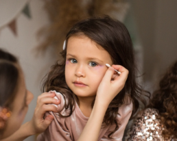 little girls applying eye shadow