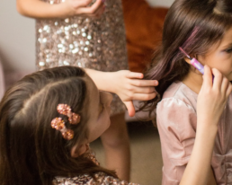 child applying hair mascara