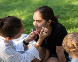 children applying make-up pencil