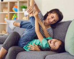 child laughing with mom