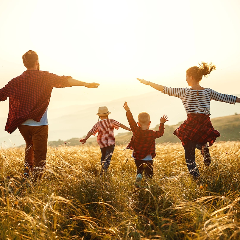 family running through the fields